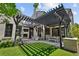 Beautiful backyard oasis with a pergola over an outdoor seating area with a fireplace and a barbecue grill at 1265 S Gaylord St, Denver, CO 80210