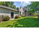 Spacious backyard features lush lawn, mature landscaping, and a charming outdoor dining and seating area at 1265 S Gaylord St, Denver, CO 80210