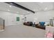 Spacious basement featuring neutral carpet, a steel beam, and two leather sofas at 1265 S Gaylord St, Denver, CO 80210