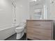 Stylish bathroom featuring subway tile and a wood vanity with chrome hardware and a shower-tub combo at 1265 S Gaylord St, Denver, CO 80210