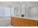 Bright bathroom showcasing double sinks, a soaking tub, and stylish fixtures and lighting at 1265 S Gaylord St, Denver, CO 80210