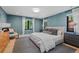 Comfortable bedroom with serene blue walls, plush bedding, and ample natural light at 1265 S Gaylord St, Denver, CO 80210