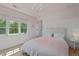Well-lit bedroom featuring a large window and a chandelier, with a white and pink color scheme at 1265 S Gaylord St, Denver, CO 80210