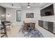 Inviting dining area with a long table, bar, and a large television at 1265 S Gaylord St, Denver, CO 80210
