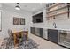 Inviting dining area features a long table, bar, beverage cooler, and decorative shelving at 1265 S Gaylord St, Denver, CO 80210
