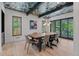 Dining room with a long wooden table, modern chandelier, and a decorative ceiling at 1265 S Gaylord St, Denver, CO 80210