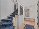 Entryway with wood floors, stairs with blue carpet, a bench, and a decorative mirror at 1265 S Gaylord St, Denver, CO 80210