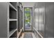Hallway with built-in shelves and cabinets leading to an outdoor seating area at 1265 S Gaylord St, Denver, CO 80210