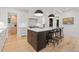 Modern kitchen featuring a large island with seating, white cabinets, and stainless steel appliances at 1265 S Gaylord St, Denver, CO 80210