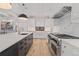 Bright kitchen boasting a large island, marble backsplash, and high-end stainless steel appliances at 1265 S Gaylord St, Denver, CO 80210
