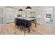 Spacious kitchen with white cabinetry, a large island, and stainless steel appliances at 1265 S Gaylord St, Denver, CO 80210