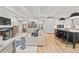 Open concept living area showcasing hardwood floors, a staircase, and modern decor leading to the kitchen at 1265 S Gaylord St, Denver, CO 80210