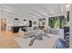 Open concept living area with a sofa, armchairs, marble fireplace, and view into the kitchen and dining area at 1265 S Gaylord St, Denver, CO 80210