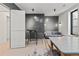 Cozy living room area featuring a bar table, plush seating, and sleek design elements at 1265 S Gaylord St, Denver, CO 80210