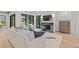 Sunlit living room with a marble fireplace, wood floors, and comfortable seating area at 1265 S Gaylord St, Denver, CO 80210
