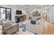 Bright living room featuring a marble fireplace, hardwood floors, and stylish decor at 1265 S Gaylord St, Denver, CO 80210