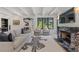 Open concept living area with a sofa, armchairs, marble fireplace, and views into the kitchen and dining area at 1265 S Gaylord St, Denver, CO 80210