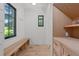 Inviting mudroom featuring a wooden bench, natural light, and custom storage cabinets at 1265 S Gaylord St, Denver, CO 80210