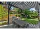 Outdoor dining area boasts a barbecue grill and ample space for gatherings under a shade-creating pergola at 1265 S Gaylord St, Denver, CO 80210