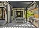 Inviting backyard patio features outdoor dining with a pergola, barbecue grill, and access to the home's interior at 1265 S Gaylord St, Denver, CO 80210