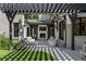 Relaxing outdoor living space has a fireplace, pergola, outdoor furniture, and access to the expansive lawn at 1265 S Gaylord St, Denver, CO 80210