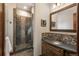 Stylish bathroom with a tiled walk-in shower, modern vanity, and attractive decorative accents at 8871 Aspen Leaf Ct, Littleton, CO 80125