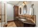 Bathroom featuring double sink, granite counters, and custom backsplash at 8871 Aspen Leaf Ct, Littleton, CO 80125