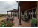 Multi-level home has multiple covered decks with outdoor dining set at 8871 Aspen Leaf Ct, Littleton, CO 80125