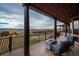 Spacious deck with mountain views features outdoor seating and a modern fire pit at 8871 Aspen Leaf Ct, Littleton, CO 80125