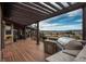 Deck with outdoor kitchen, pergola, and mountain views at 8871 Aspen Leaf Ct, Littleton, CO 80125
