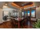 Elegant dining room with wood floors, tray ceiling, access to the back deck and living room at 8871 Aspen Leaf Ct, Littleton, CO 80125