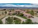 Aerial view of a home with landscaped grounds, circular driveway, and mountain views in the background at 8871 Aspen Leaf Ct, Littleton, CO 80125