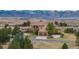 Expansive home with a tile roof and mountain views, plus a circular driveway and two-car garage at 8871 Aspen Leaf Ct, Littleton, CO 80125