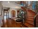 Elegant foyer boasts hardwood floors, curved staircase with iron railing, and arched doorways at 8871 Aspen Leaf Ct, Littleton, CO 80125