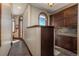 Hallway with tile flooring leads to an arched window and kitchen at 8871 Aspen Leaf Ct, Littleton, CO 80125