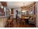Eat-in kitchen area with bar and stone wall at 8871 Aspen Leaf Ct, Littleton, CO 80125
