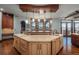 Custom kitchen featuring stone accent wall, large island, and scenic views at 8871 Aspen Leaf Ct, Littleton, CO 80125