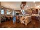 Open kitchen boasts an island, breakfast nook, and stone accents at 8871 Aspen Leaf Ct, Littleton, CO 80125