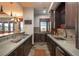 Well-appointed kitchenette featuring stainless steel appliances, granite countertops, and custom cabinetry at 8871 Aspen Leaf Ct, Littleton, CO 80125