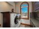 Laundry room features a modern washer and dryer set with built-in cabinets at 8871 Aspen Leaf Ct, Littleton, CO 80125