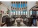 Elegant living room with high ceilings, large windows, and cozy seating at 8871 Aspen Leaf Ct, Littleton, CO 80125