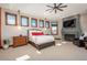 Charming primary bedroom features carpet floors, a fireplace, and an ensuite bathroom at 8871 Aspen Leaf Ct, Littleton, CO 80125