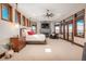 This stylish primary bedroom features a ceiling fan, a fireplace, and an ensuite bathroom at 8871 Aspen Leaf Ct, Littleton, CO 80125