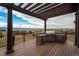 Outdoor grill area with pergola offers stunning views, bar seating, and stone accents at 8871 Aspen Leaf Ct, Littleton, CO 80125