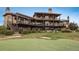 Large home with multiple balconies overlooks putting green and expansive yard at 8871 Aspen Leaf Ct, Littleton, CO 80125