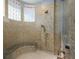 Shower features mosaic tile, a built-in bench, and bronze fixtures at 8871 Aspen Leaf Ct, Littleton, CO 80125