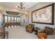 Bright sitting area featuring a large world map, comfortable seating, and scenic views from expansive windows at 8871 Aspen Leaf Ct, Littleton, CO 80125