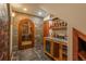Elegant wine room with stone accents, custom wine storage, and a climate-controlled environment at 8871 Aspen Leaf Ct, Littleton, CO 80125
