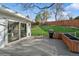 Back deck with a grill and planter boxes overlooks a lush green lawn through a sliding door at 11600 W 31St Pl, Lakewood, CO 80215