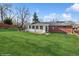 Exterior view of the home with a well-maintained lawn, back patio, and sunroom at 11600 W 31St Pl, Lakewood, CO 80215